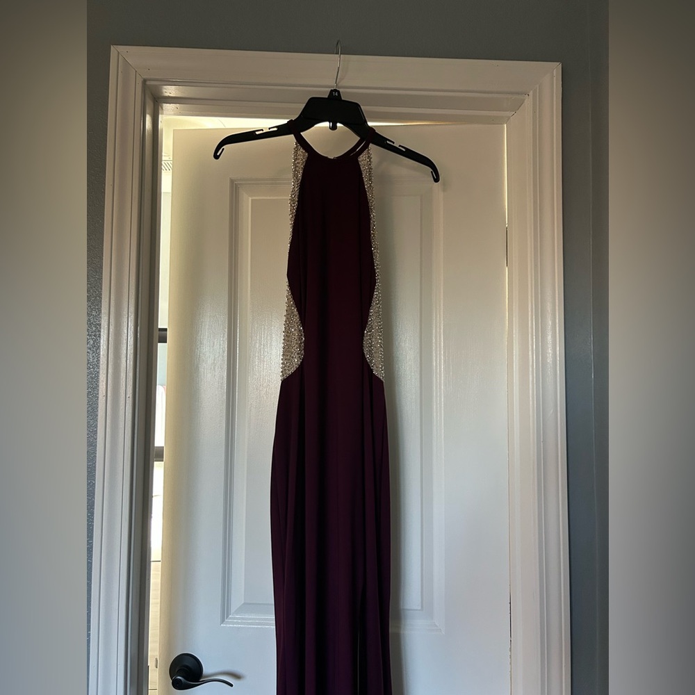 Burgandy and silver beaded maxi dress with a side slit on the leg.